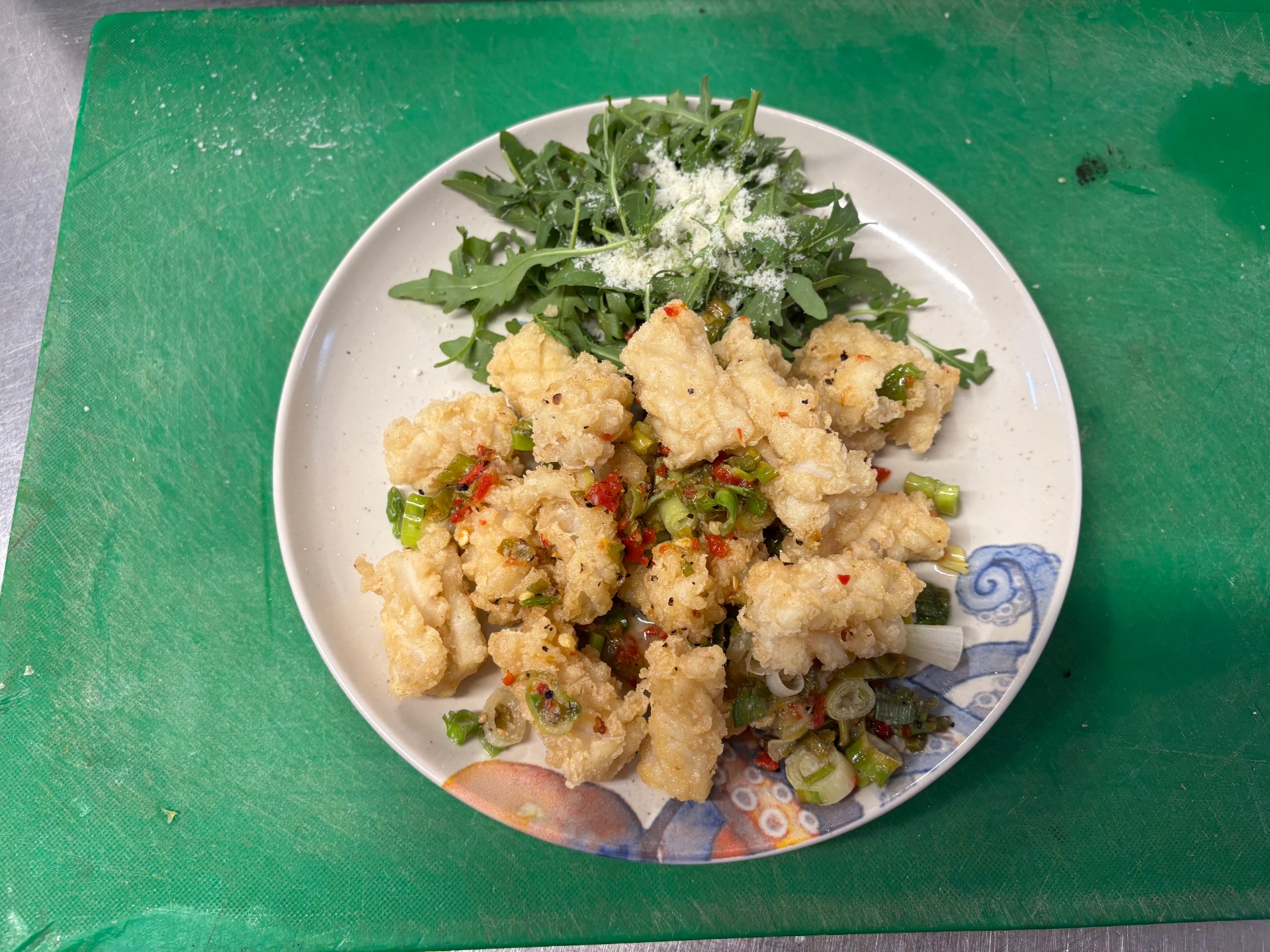 Crispy salt and chilli squid with rocket and parmesan