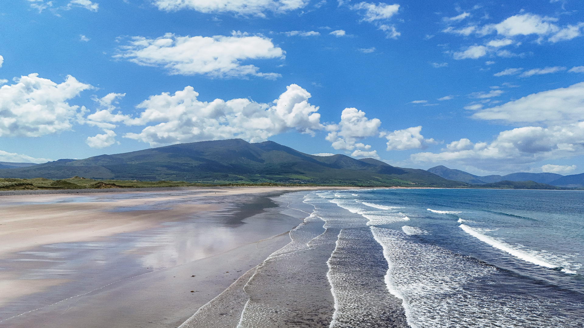 Wide sandy beach with Atlantic waves and the Brandon mountains beyond