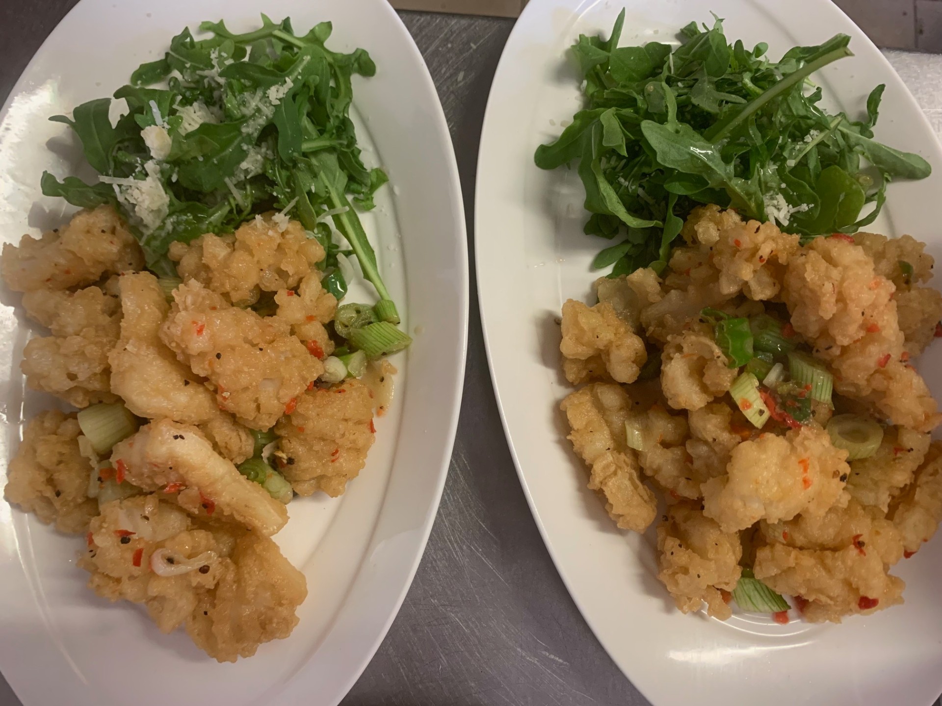 Two plates of salt and chilli squid ready to be served