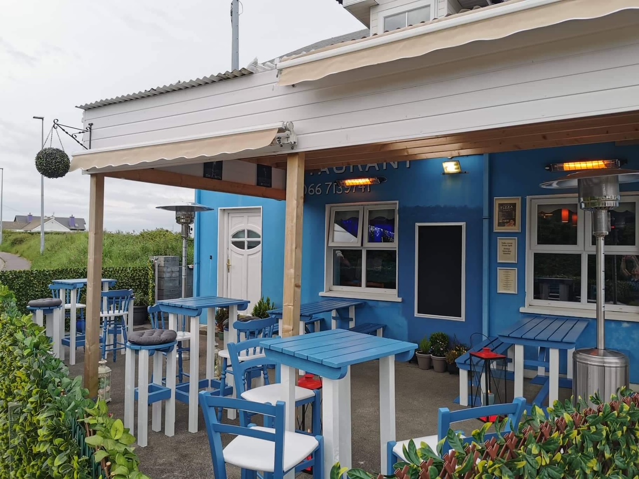 Pisces Restaurant's blue exterior and covered outdoor seating on Strand Road