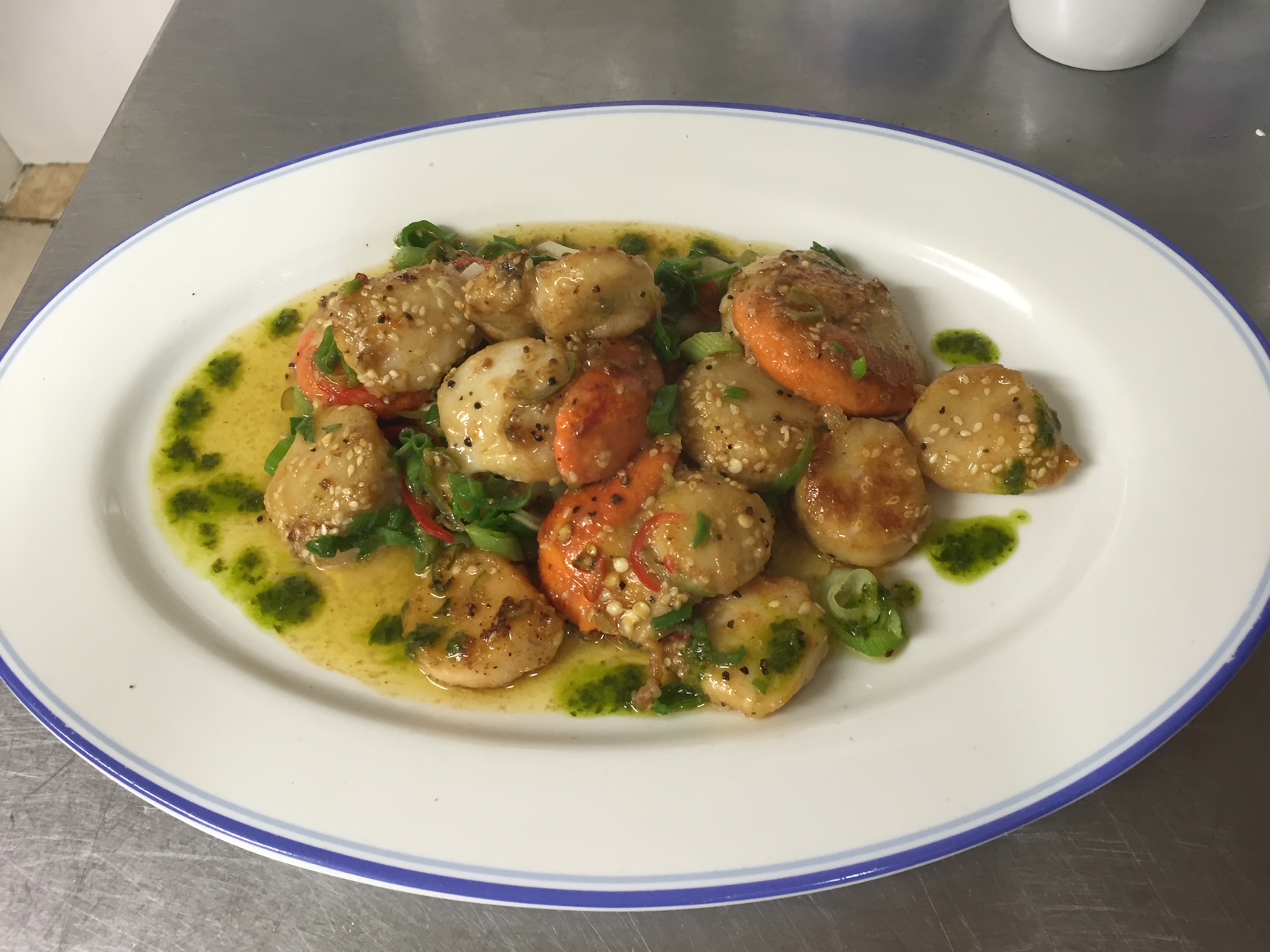 Seared scallops and Killarney prawns with chilli, spring onion and herb oil