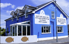Pisces Restaurant — bright blue exterior on Strand Road, Castlegregory